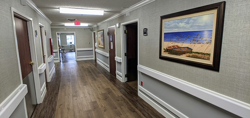 edisto post acute hallway with paintings hanging on the wall