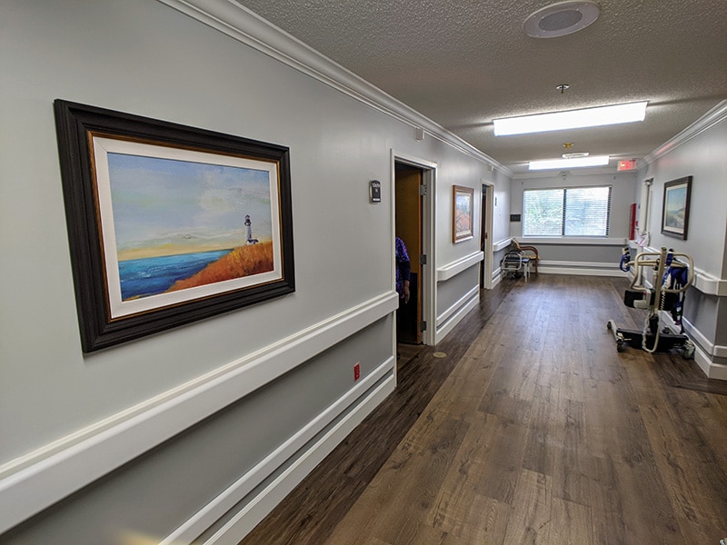 Edisto Post Acute hallway with paintings hanging on the wall