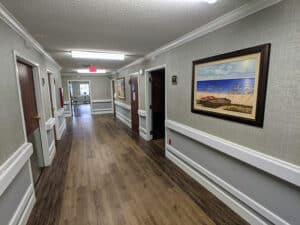 Edisto Post Acute hallway with paintings hanging on the wall