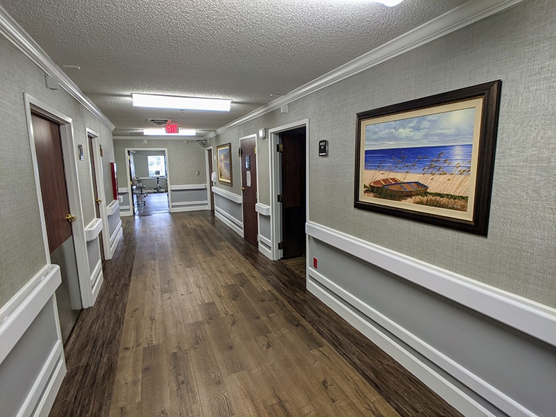 Edisto Post Acute hallway with paintings hanging on the wall