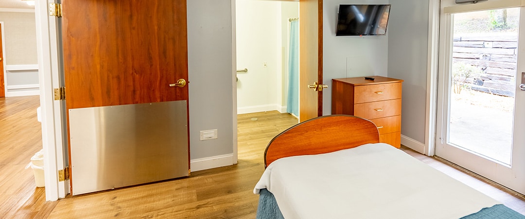 edisto post acute single room and bathroom with bed and dresser